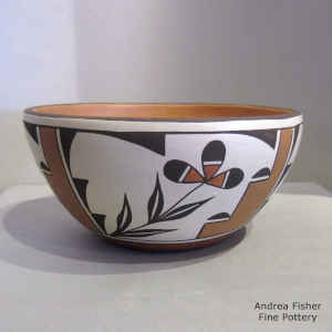 Flower, kiva step, cloud and geometric design on the outside of this polychrome bowl with red micaceous slip on the inside