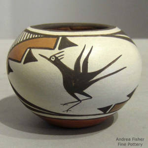 Roadrunner, clouds and geometric designs decorate a polychrome jar