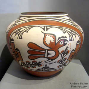 Bird, cloud, rainbow and geometric design on a polychrome jar