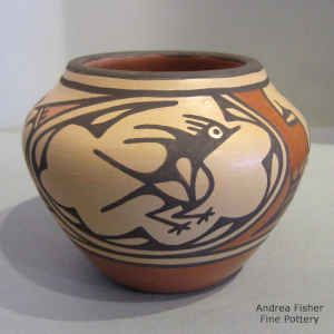 Bird, rainbow, flowers, rain clouds and geometric design on a polychrome jar