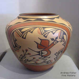 Roadrunner, flower, rainbow and geometric design on a polychrome jar