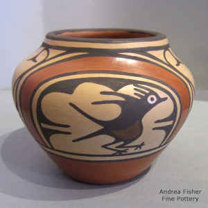 Bird, rainbow, flowers, rain cloud and geometric design on a polychrome jar
