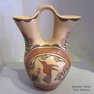 Hummingbird, rainbow, flower, rain clouds and geometric design on a polychrome jar