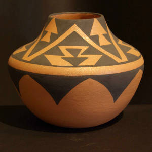 Micaceous golden jar with a black geometric design
