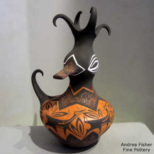 Deer, heart line and geometric design on a polychrome duck pot