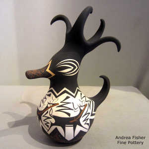 Deer, heart line and geometric design on a small polychrome duck pot