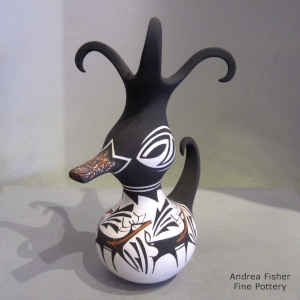 Deer, heart line and geometric design on a polychrome duck pot
