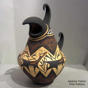 Deer, heart line and geometric design on a polychrome parrot effigy