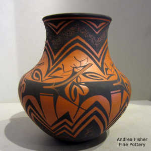 Deer, heart line and geometric design on a red and black jar