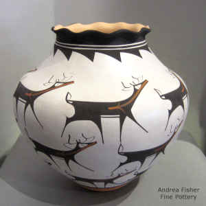 Deer, heart line and geometric design on a polychrome jar