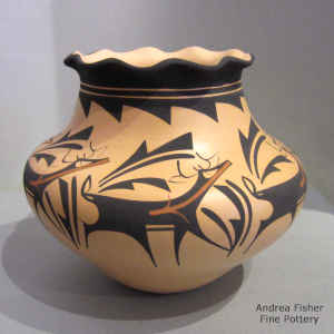 Deer, heart line and geometric design on a polychrome jar with a pie crust rim