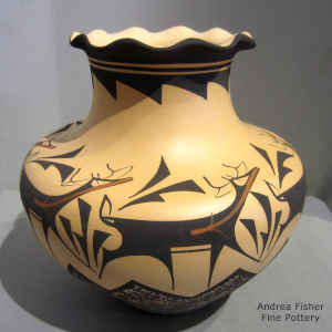 Deer, heart line and geometric design on a polychrome jar with a pie crust rim