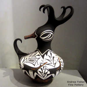 Deer, heart line and geometric design on a polychrome duck pot