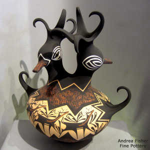 Deer, heart line and geometric design on a polychrome duck pot with two heads