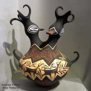Deer, heart line and geometric design on a polychrome double-headed duck pot