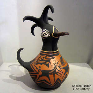 Deer, heart line and geometric design on a small polychrome duck pot