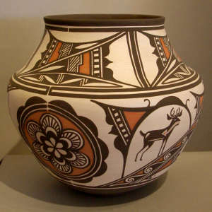 Deer-in-house, heartline, rosette and geometric design on a polychrome white ware jar