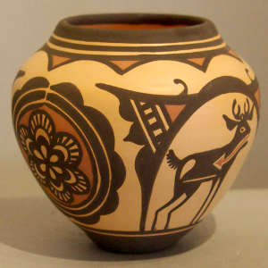 Deer-in-house, heartline, rosette and geometric design on a polychrome jar