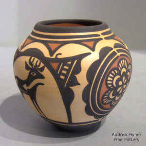 Deer, heart line, rosette and geometric design on a polychrome jar