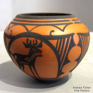 Deer, heart-line, rainbow, cloud and geometric designs on a black on orange jar