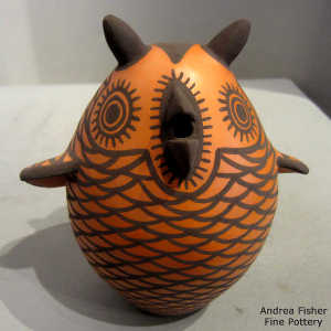 Brown owl with a black and red geometric design