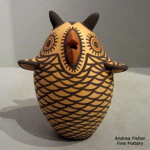 Beige owl with a black and red geometric design