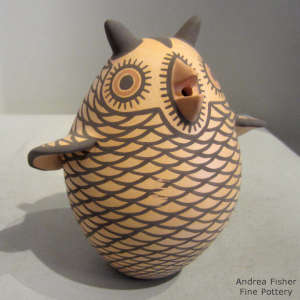 Brown owl with a black and red geometric design