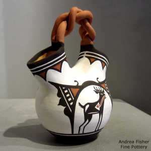 Deer-in-his-house and geometric design on a polychrome wedding vase with a twisted handle