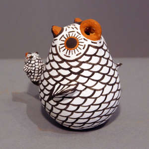 Chick mounted on the tail of an owl figure