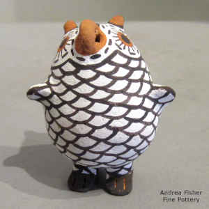 A polychrome owl figure with feet