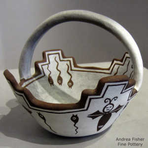 Tadpole and dragonfly design decorate a black and white prayer bowl